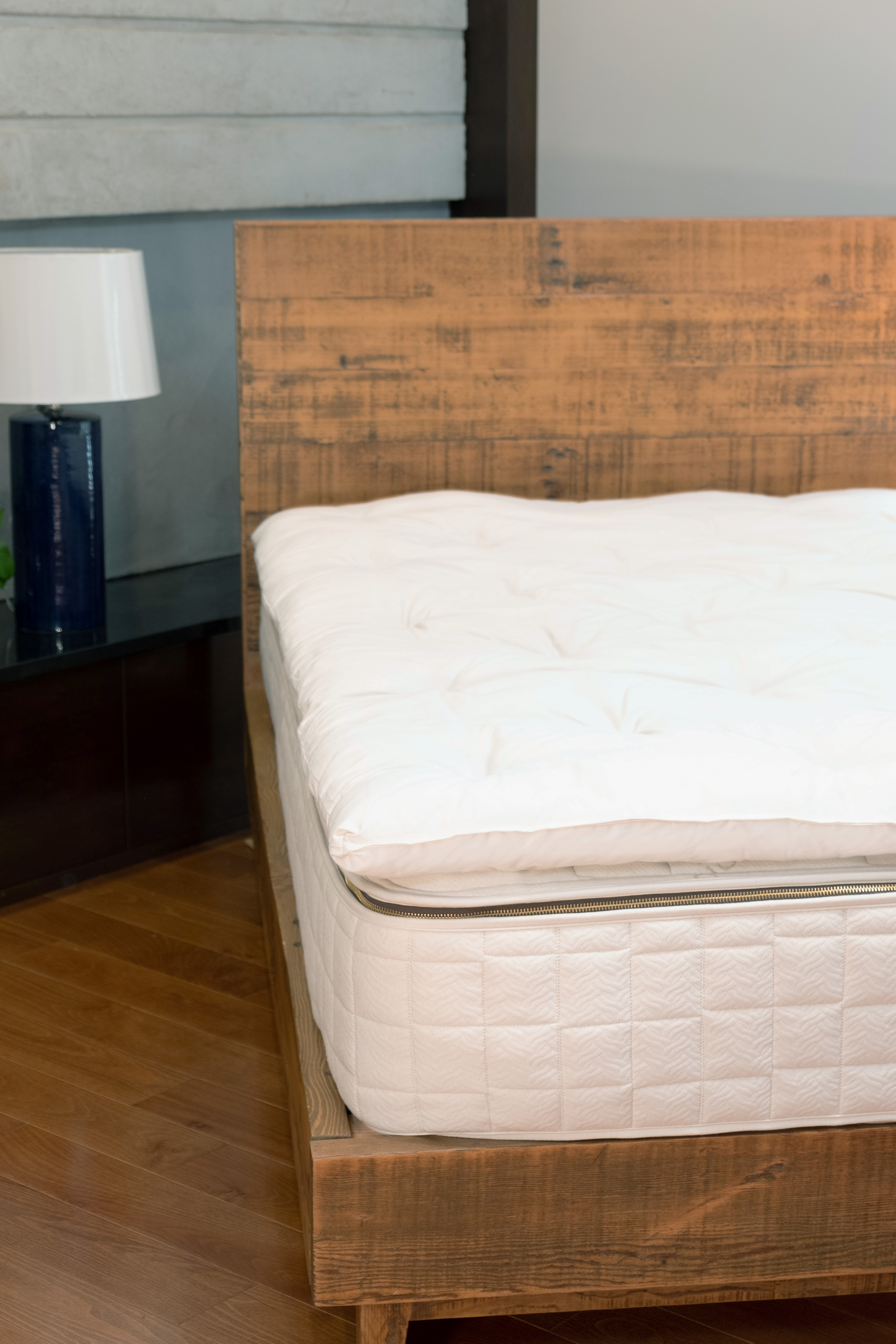 Naturepedic Wooly Mattress Topper showcased in a plush, luxurious bedroom setting.